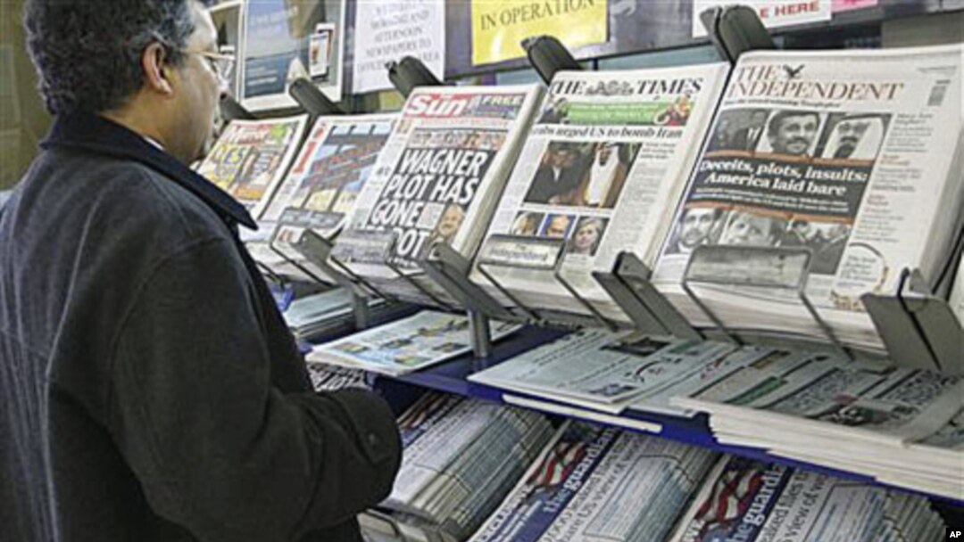 A man views a news stand displaying newspapers, some carrying the story on WikiLeaks' release of classified US State Department documents, in London.