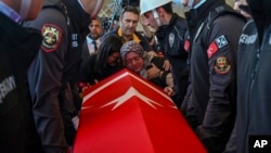 Relatives of Hasan Huseyin Canbaz, who was killed in an attack by PKK members at the Turkish aerospace and defense company TUSAS on Wednesday, mourn during a funeral at Karsiyaka mosque in Ankara, Oct. 24, 2024. 