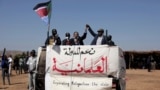 FILE - Sudanese Prime Minister Abdalla Hamdok, left, and The Sudan Liberation Movement-North leader, Abdel-Aziz Adam al-Hilu, hold up their hands in the conflict-affected remote town of Kauda, Nuba Mountains, Sudan, Jan. 9, 2020.