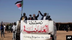 FILE - Sudanese Prime Minister Abdalla Hamdok, left, and The Sudan Liberation Movement-North leader, Abdel-Aziz Adam al-Hilu, hold up their hands in the conflict-affected remote town of Kauda, Nuba Mountains, Sudan, Jan. 9, 2020.