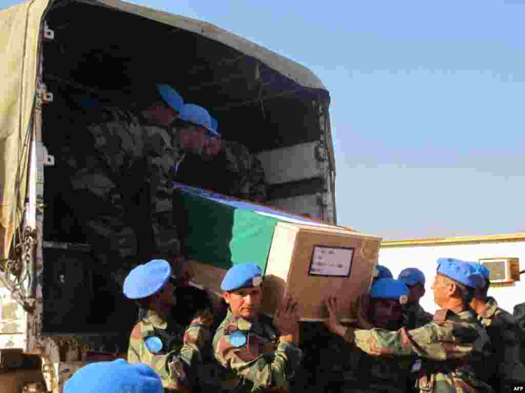 Handout photo taken Dec. 20, 2013 released by UN Mission in South Sudan (UNMISS) shows the remains of two UN soldiers from the Indian Battalion who were killed in an attack on a U.N. base in Akobo, in Jonglei state. (AFP Photo /UNMISS/Rolla Hinedi)