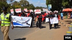 FILE - Protesters march against attacks on people with albinism in Lilongwe, the capital of Malawi, in early 2016.