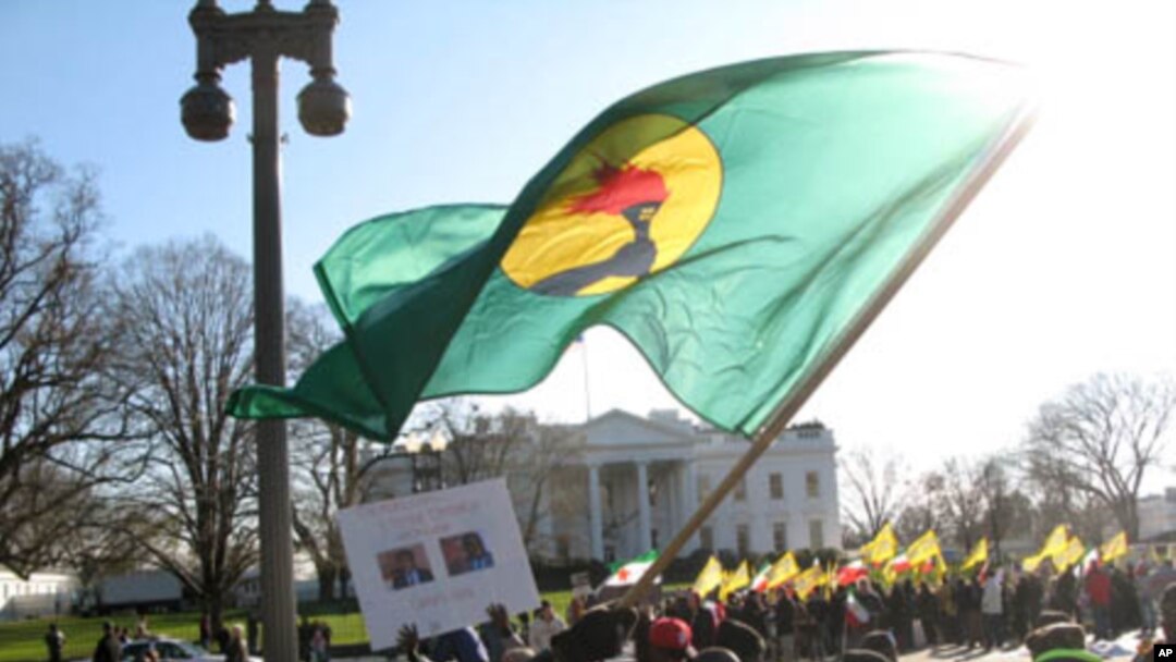 A Congolese protester waves a flag of the former Zaire in front of the White House Saturday, December 10, 2011, denouncing recent election results in the Democratic Republic of Congo.