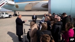 FILE - President Donald Trump speaks with reporters as he boards Air Force One as he departs, Feb. 18, 2020, at Andrews Air Force Base, Md.