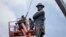 Workers prepare to take down the statue of former Confederate general Robert E. Lee, which stands more than 100 feet tall, in Lee Circle in New Orleans, May 19, 2017.