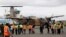 A Kenyan military aircraft carrying some of the bodies of those killed in the Mandera quarry attack, arrives at Wilson Airport in Nairobi, Kenya,Tuesday, Dec. 2, 2014.