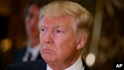 President-elect Donald Trump speaks to reporters in the lobby of Trump Tower in New York, Jan. 9, 2017.