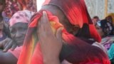 FILE - Women from the city of Al-Junina (West Darfur) cry after receiving the news about the death of their relatives as they waited for them in Chad, November 7, 2023. 