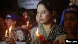 Women hold lighted candles during a rally condemning the attack on schoolgirl Malala Yousufzai, in Karachi, Pakistan, October 11, 2012.