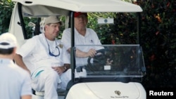 U.S. President Donald Trump arrives to play host to members of the U.S. Coast Guard he invited to play golf at his Trump International Golf Club in West Palm Beach, Fla., Dec. 29, 2017.