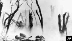 FILE - A U.S. Army 37-mm gun crew man their position during the World War I Meuse-Argonne Allied offensive in France, Sept. 26, 1918. 