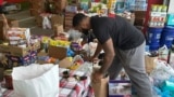 FILE - N.C. State defensive end Davin Vann works among the donations collected to help Hurricane Helene victims in western North Carolina, Wednesday, Oct. 2, 2024 in Raleigh, N.C. (AP Photo/Aaron Beard)