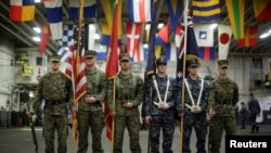 A flag party of U.S. Marines and Navy personnel take part in a ceremony marking the start of Talisman Saber 2017, a biennial joint military exercise between the U.S. and Australia aboard the USS Bonhomme Richard off the coast of Sydney, Australia, June 29