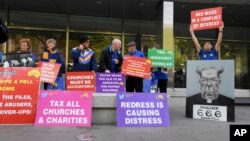 Protesters gather outside the County Court during the sentencing of Cardinal George Pell in Melbourne, Australia, Wednesday, March.13, 2019.