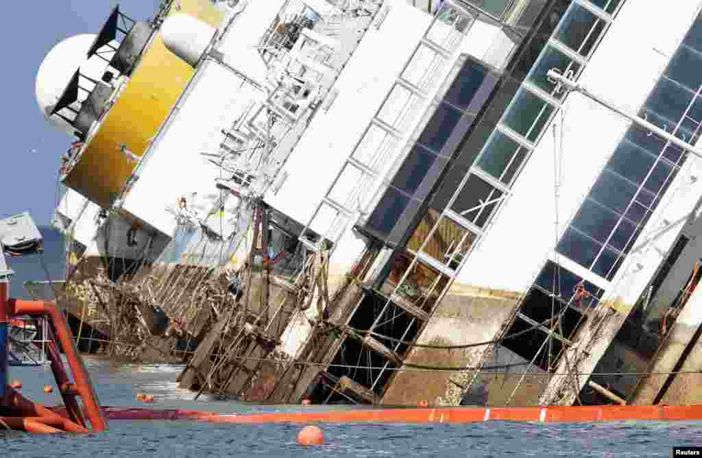 The capsized Costa Concordia cruise liner is pictured after the start of the operation to tilt the ship upright outside Giglio harbor, Italy, Sept. 16, 2013. 