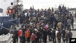 South Koreans surrounded by relatives and media as they arrive at port in Incheon, west of Seoul, South Korea, 24 Nov 2010