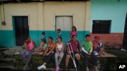 El migrante venezolano Jesús González, con una sola muleta, se sienta con su familia, que forma parte de una caravana migrante que se detuvo a descansar en Huixtla, estado de Chiapas, México, el miércoles 8 de junio de 2022. Foto AP.