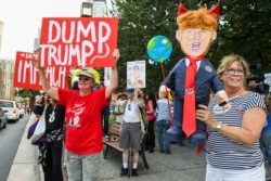Anti-Trump demonstrators protest prior to U.S. President Donald Trump's speech to Republican members of Congress in Baltimore, Maryland.