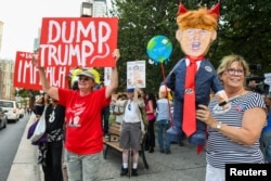 Anti-Trump demonstrators protest prior to U.S. President Donald Trump's speech to Republican members of Congress in Baltimore, Maryland.