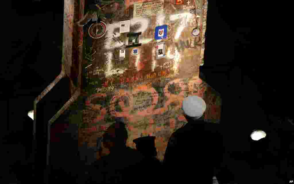 Seorang petugas pemadam kebakaran New York City melihat pilar terakhir yang diperbaiki di World Trade Center pada upacara penghormatan bagi Museum Memorial Nasional 11 September di New York, 15 Mei 2014.