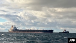 A handout photo released by the German Central Command for Maritime Emergencies on Jan. 10, 2025, shows the tanker Eventin as a towing connection is established from a tug boat at sea north of the German Baltic Sea island of Ruegen. 