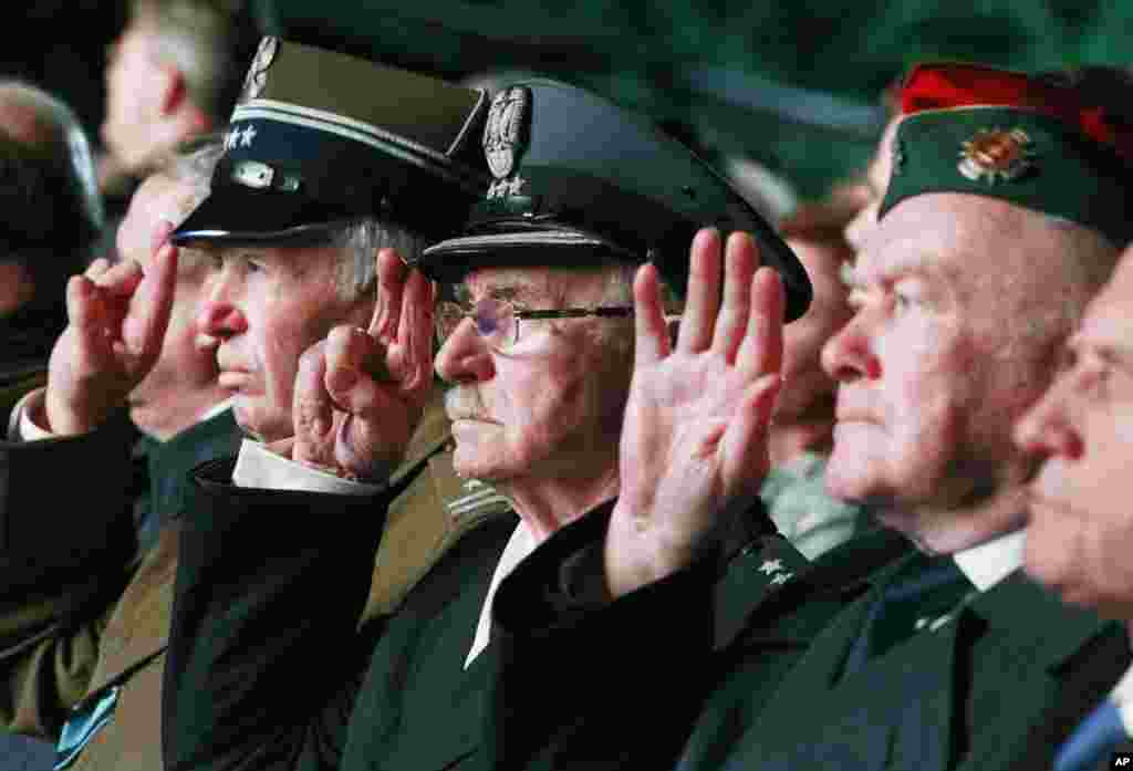 Polish veteran military officers salute during a ceremony marking the 70th anniversary of the end of World War II, at Westerplatte, near Gdansk, Poland, May 8, 2015.