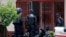 Zimbabwean riot police are seen outside the offices of the Trade Union in Harare, Oct, 11, 2018. 