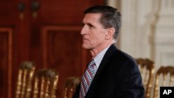 FILE - National Security Adviser Michael Flynn sits before the start of the news conference of President Donald Trump and Japanese Prime Minister Shinzo Abe in the East Room of the White House, Feb. 10, 2017. The House intelligence committee is issuing subpoenas for Flynn and Michael Cohen, Trump's personal lawyer, as well as their businesses.