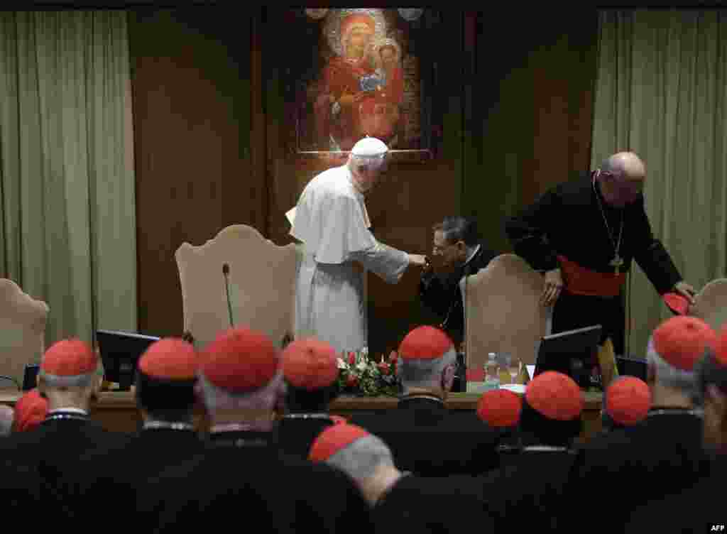 Pope Benedict XVI is greeted as he arrives to meet cardinals he summoned for a day of reflection at the Vatican, Friday, Nov. 19, 2010, the day before a ceremony to create 24 new cardinals. The top agenda, religious freedom, grew remarkably timely given C