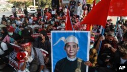 FILE - An image of deposed Myanmar President Win Myint is displayed at an anti-coup rally in Yangon, Myanmar, Feb. 20, 2021. 