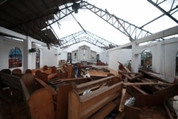 The roof and pews of the St. Francis of Assisi church in Malinao town are damaged from powerful winds of Typhoon Goni in Albay province, central Philippines, Nov. 3, 2020.