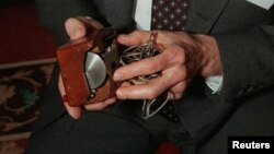 An April 9, 1997 photo of Doug Engelbart, inventor of the computer mouse and winner of the half-million dollar 1997 Lemelson-MIT prize, posing with the computer mouse he designed, in New York.