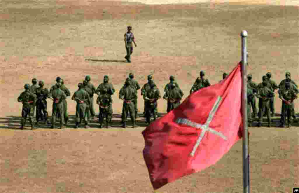 ADVANCE FOR USE SUNDAY, MARCH 4, 2012 AND THEREAFTER - In this Feb. 13, 2012 photo, recruits of the Kachin Independence Army (KIA), one of the country's largest armed ethnic groups, undergo training near a KIA flag at a military camp near Laiza, the area 