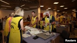 Election officials start counting the votes from the parliamentary elections in Tirana, Albania, June 26, 2017. 