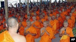 In this 2005 file photo, some 480 hill tribe ethnic minority men temporarily entered the Buddhist monkhood for five days at a ceremony in Chiang Mai, Thailand, after the Thai government granted them citizenship, and they became monks to celebrate