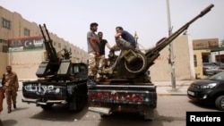 Libyan militias blockade the Justice Ministry in Tripoli April 30 demanding the ouster of officials linked to the late Moammar Gadhafi.