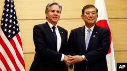 U.S. Secretary of State Antony Blinken, left, shakes hands with Japanese Prime Minister Shigeru Ishiba at Ishiba's office in Tokyo, Jan. 7, 2025.