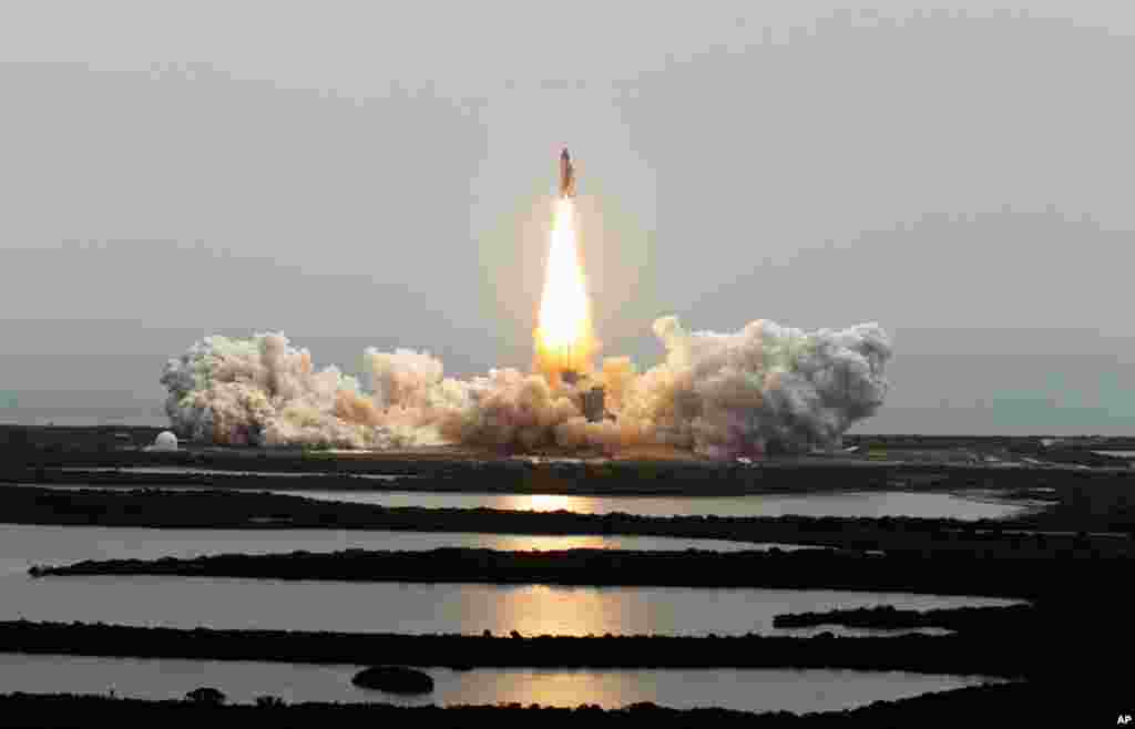 July 8: The space shuttle Atlantis lifts off from the Kennedy Space Center in Cape Canaveral, Fla. Atlantis is the 135th and final space shuttle launch for NASA. (AP Photo/Chris O'Meara)