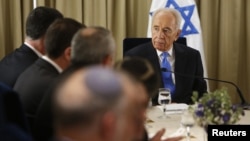 srael's President Shimon Peres (R) sits next to representatives of Israeli Prime Minister Benjamin Netanyahu's Likud-Beitenu party in Jerusalem Jan. 30, 2013, after receiving the official results of the general elections held Jan. 22.