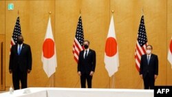 美国国务卿布林肯（中）和美防长奥斯汀（左）在东京与日本首相菅义伟合影。（2021年3月16日）