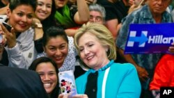 FILE - In this May 5, 2016 file photo, Democratic presidential candidate Hillary Clinton takes a photo with supporters at the end of a campaign stop at East Los Angeles College in Los Angeles. (AP Photo/Damian Dovarganes)