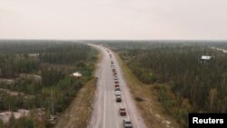 Antrean kendaraan mengular saat para warga berusaha meninggalkan Yellowknife, Kanada, di tengah kebakaran hutan yang melanda kawasan tersebut pada 16 Agustus 2023. (Foto: Reuters/Pat Kane)