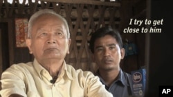 Brother No. 2. Nuon Chea, sits with reporter Thet Sambath in this still from the movie "Enemies of the People."