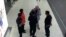 In this image made from airport closed circuit television video and provided by Fuji Television, Kim Jong Nam, exiled half-brother of North Korea's leader Kim Jong Un, gestures towards his face while talking to airport security and officials at Kuala Lump