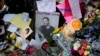 FILE - A picture of former One Direction singer Liam Payne sits surrounded by flowers and candles as fans gather outside the hotel where he was found dead after falling from a balcony in Buenos Aires, Argentina, Oct. 17, 2024. 