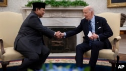 U.S. President Joe Biden shakes hands with Indonesia's President Prabowo Subianto, left, during a meeting in the Oval Office of the White House in Washington, Nov. 12, 2024.