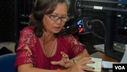 Mu Sochua, member of parliament-elect election from Cambodia's opposition National Rescue Party talks on VOA Khmer's Hello VOA radio call-in show in Phnom Penh, Wednesday, July 23, 2014, about her experience leading non-violent protests, one day after she was released from prison. (Lim Sothy/VOA Khmer)