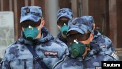 Members of Russia's National Guard wear respirators as the patrol a street during a subdued observance of the 75th anniversary of the Allied victory over Nazi Germany in World War II, amid the coronavirus pandemic, in Moscow, Russia, May 9, 2020. 