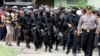 Members of the anti-terror police arrive at the village of Batu Rengat, where police exchanged fire with suspects in a house in Bandung, West Java province, May 8, 2013. 