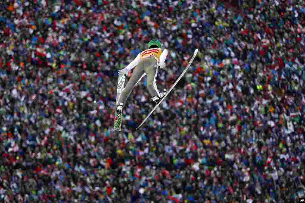 Peter Prevc of Slovenia soars through the air during his first competition jump at the third stage of the 64th four hills ski jumping tournament in Innsbruck, Austria.